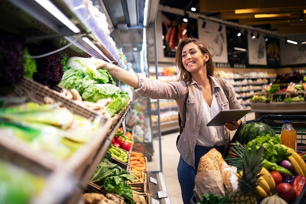 Free Photo | Choosing best vegetables on the shelf in grocery store