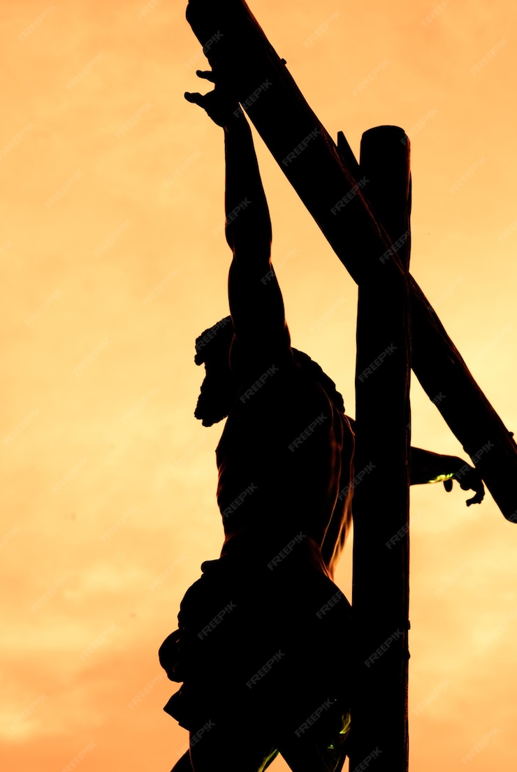 Premium Photo | Christ crucified against the light during the sunset