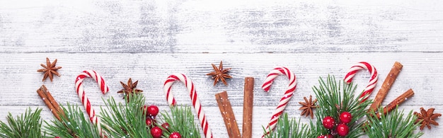 Christmas background. fir branches, candy cane and gifts on wooden ...