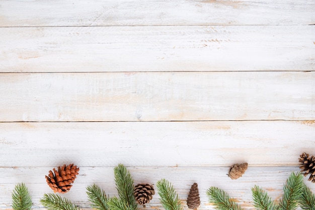 Premium Photo Christmas Background Fir Leaves And Pine Cones Decorating Elements Rustic On White Wood Table Creative Flat Layout And Top View Composition With Border And Copy Space Design