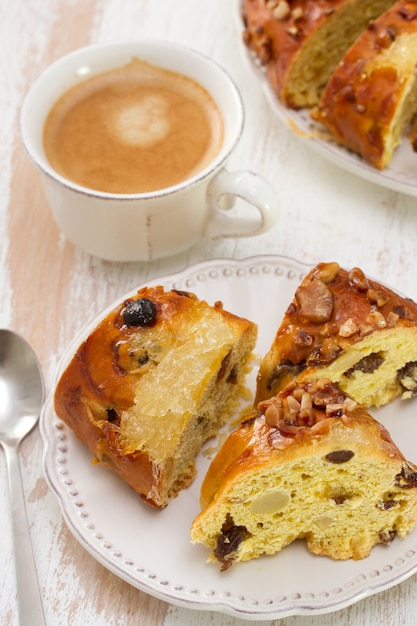 Christmas Cake With Dry Fruits On White Plate With Cup Of Coffee