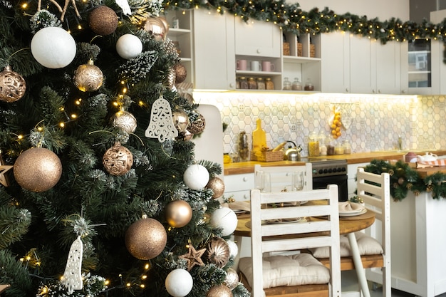 Premium Photo | Christmas decorated christmas tree on the kitchen