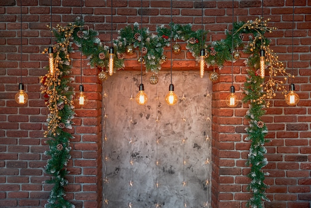 Christmas decorations and a garland of lamps on a brick wall | Premium ...