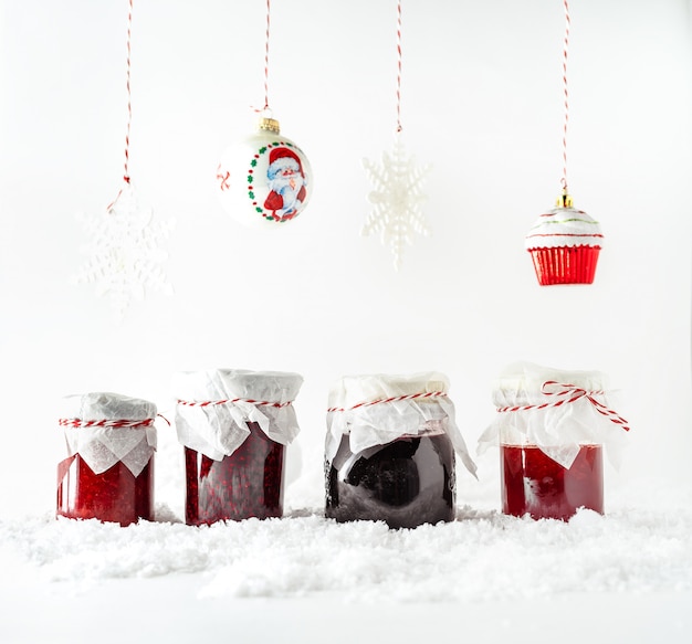 Premium Photo Christmas Decorations Hanging Down On Rope Variety Of Fruit Jams In Glass Jars Standing