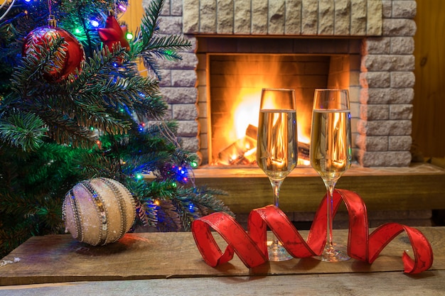 Christmas Eve Champagne Wine On A Table Near Cozy Fireplace