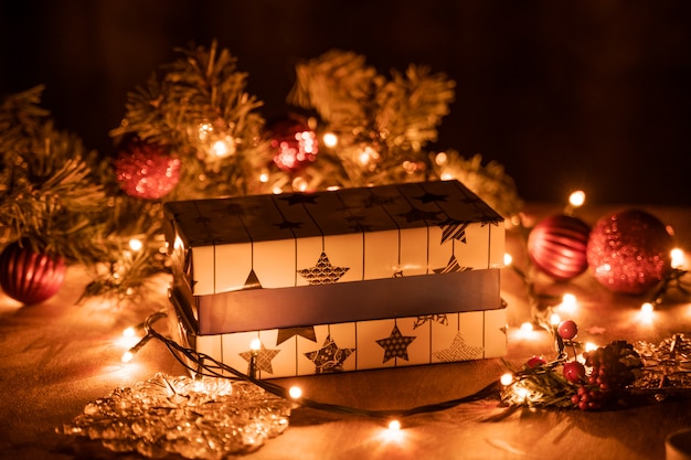 Premium Photo Christmas Gift Boxes Decoration With Christmas Tree And Candle Lights On The Wooden Table With Bokeh Lights