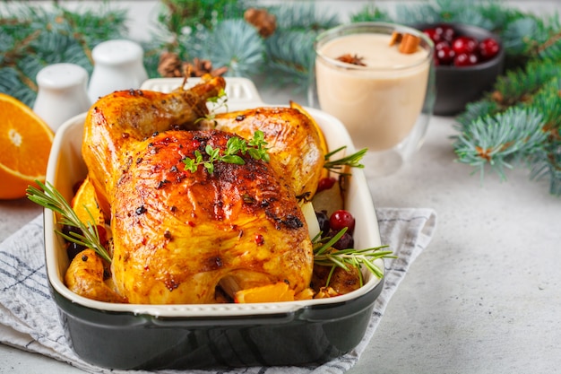 Premium Photo | Christmas roasted chicken with cranberries, orange ...