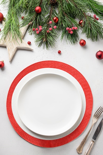 Premium Photo Christmas Table Setting With White And Red Elegant Decorations On White Table View From Above Vertical Format