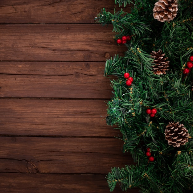 Free Photo | Christmas tree branches on a wooden background