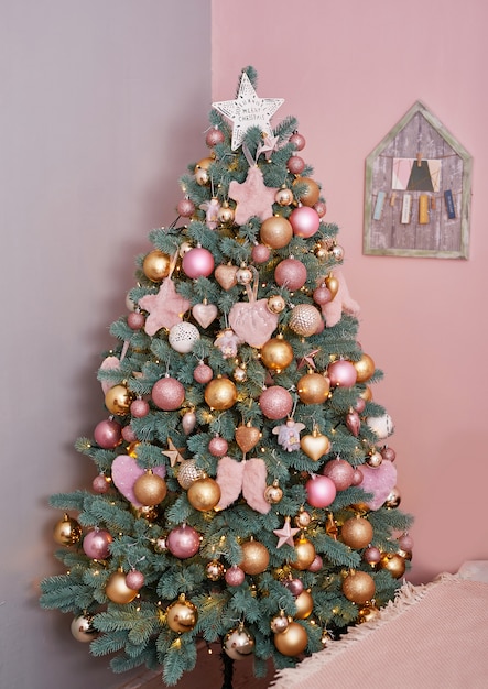ピンクのロフトスタイルのインテリアのクリスマスツリー 冬のインテリア寝室のクリスマスツリー プレミアム写真