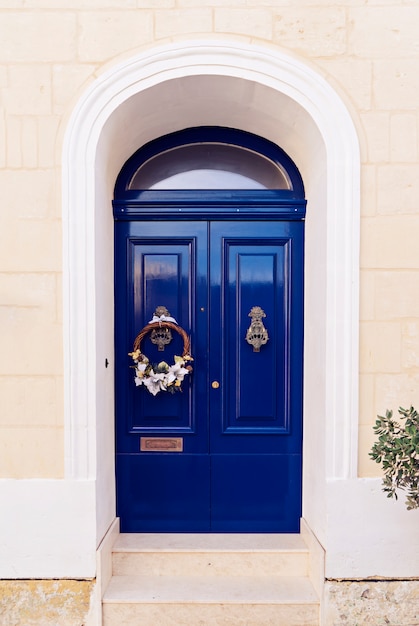 Premium Photo  Christmas wreath on the blue door