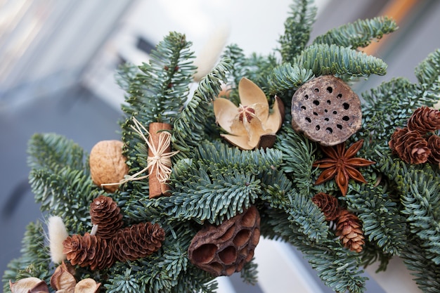 Premium Photo Christmas Wreath Made Of Natural Fir Branches Hanging On The Back Of White Chair Wreath With Natural Ornaments Bumps Walnuts Cinnamon Cones Christmas Decor