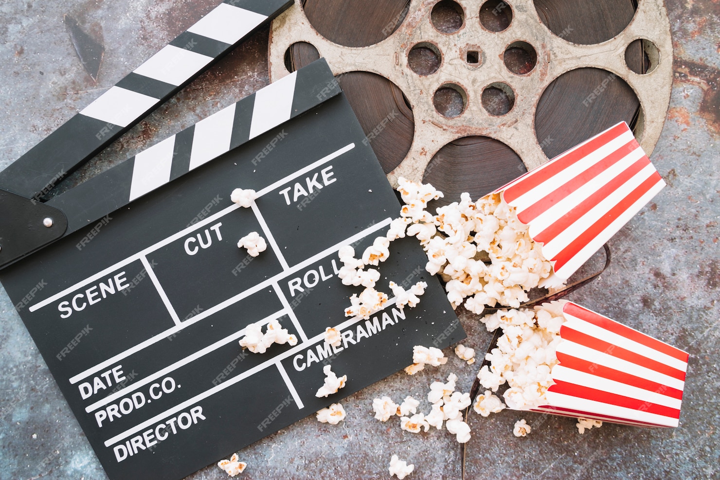 Free Photo | Cinema clapperboard with popcorn box