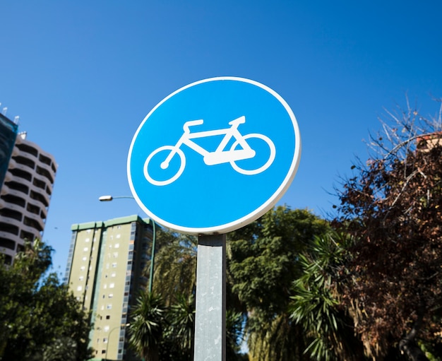 Premium Photo | Circular bike path sign against blue sky