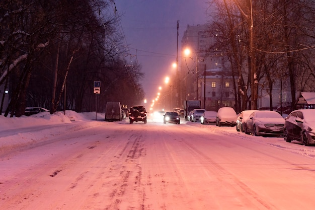 Premium Photo | City road covered with snow with cars on the sidelines ...