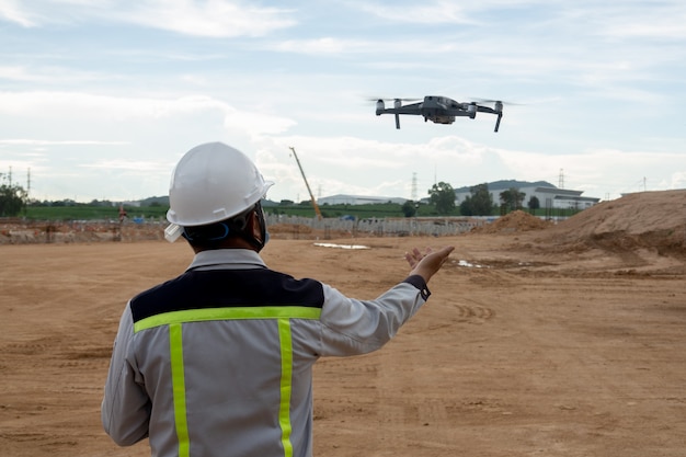 Civil engineer control the drone for inspection construction work Premium Photo