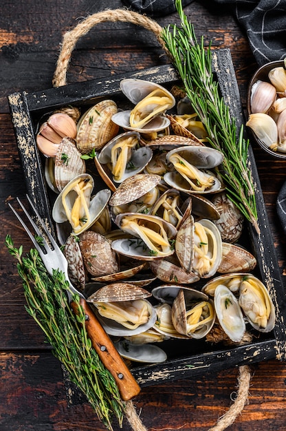 Premium Photo | Clams vongole in a wooden tray with herbs