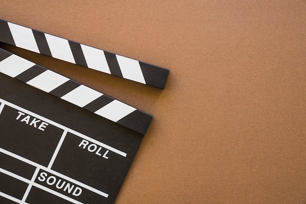 Free Photo | Clapperboard on brown background