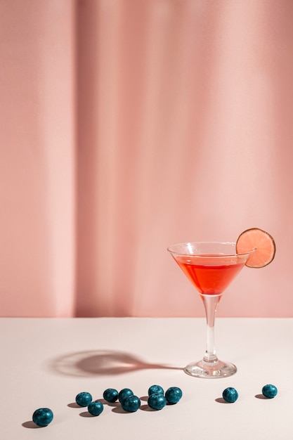 Classic margarita cocktail with lemon and riped blue berries on white table Free Photo