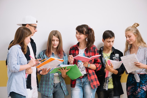 Classmates standing with textbooks Free Photo