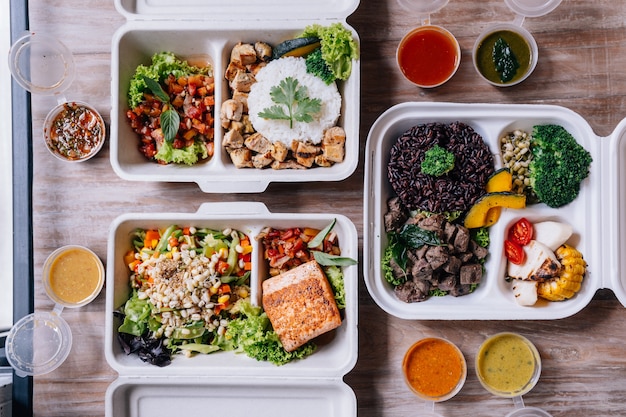 Premium Photo | Clean food meal boxes: rice and rice berry with beef, salmon and chicken with vegetables a