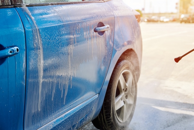 Premium Photo | Cleaning car with high pressure water at car wash station