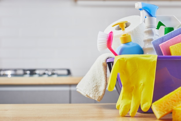 Cleaning set: sponge,  bottle , glove, brush, spray on table and gray Premium Photo