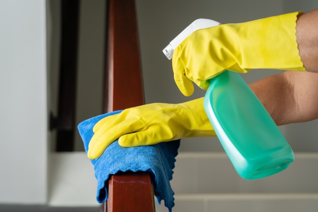 Premium Photo | Cleaning stair handrail with alcohol spray