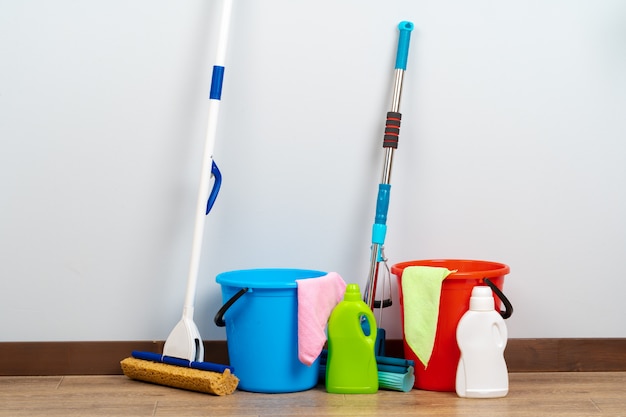 Cleaning tools for house cleaning on wooden floor | Premium Photo