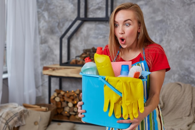 Premium Photo A Cleaning Woman Is Standing In Living Room Holding A Blue Bucket Fulfilled With