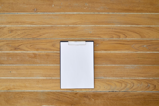 Premium Photo | Clipboard with white sheet on wooden background