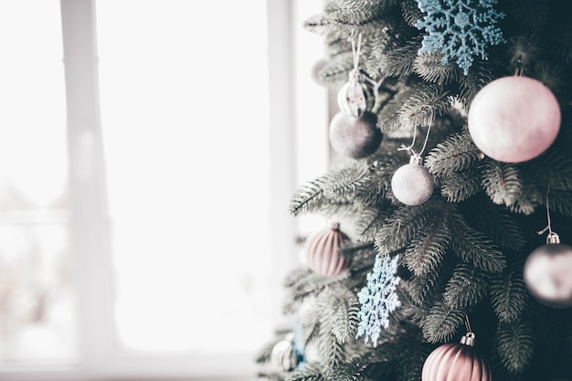 新年の準備ができているクリスマスツリーの装飾された部分のクローズアップとカットビュー 木の周りのピンクと白の装飾 プレミアム写真