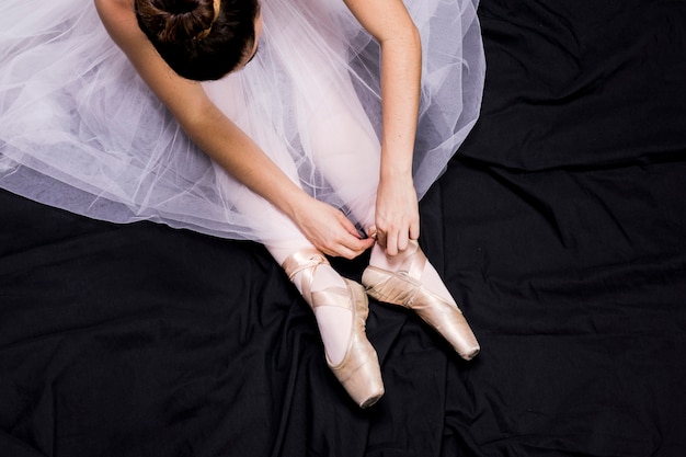 Free Photo Close Up Ballerina Tying Her Pointe Shoes