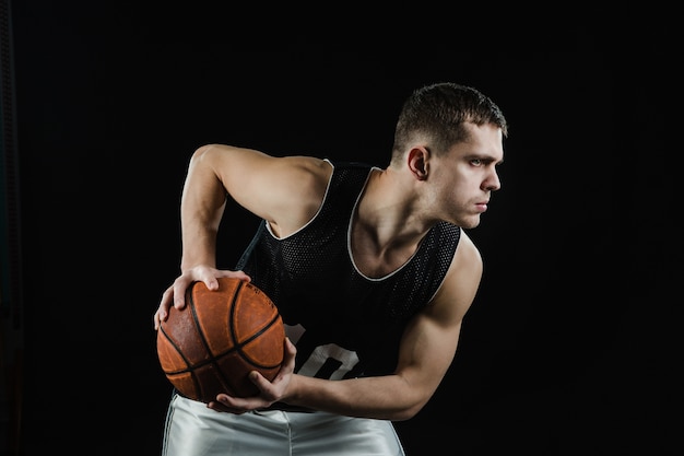 Free Photo Close Up Of Basketball Player With Ball On Black Background