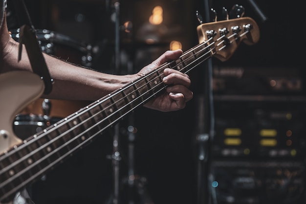 Premium Photo | Close up of bass guitar on blurred dark background copy ...