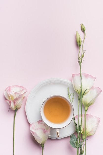 Close up of beautiful  eustoma flowers  with cup of tea 