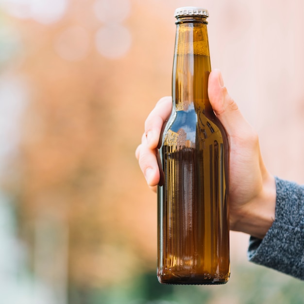 Free Photo | Close-up of a beer bottle in hand