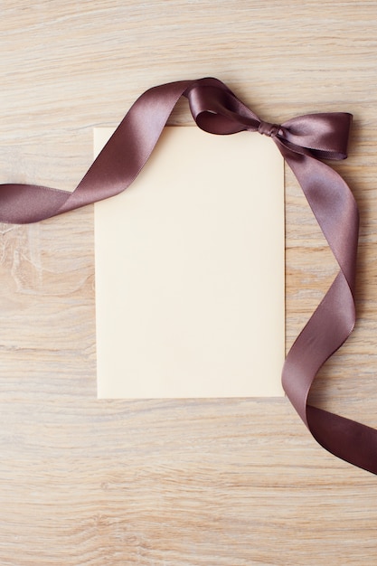Premium Photo | Close up of blank card note with brown ribbon