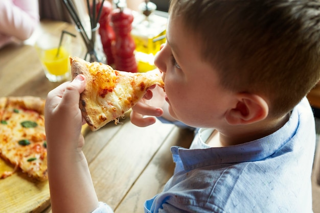 Free Photo | Close up boy with pizza slice