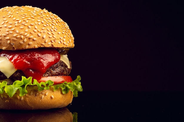 Close-up burger with black background Photo | Free Download