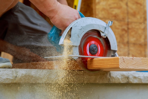 Premium Photo Close Up Of A Carpenter Using A Circular Saw To Cut A