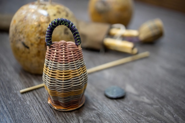 Close-up on caxixi dobrao with berimbau on the wooden floor Premium Photo