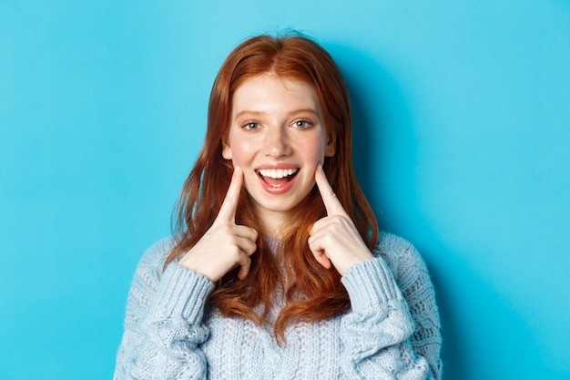 Premium Photo | Close-up of cheerful teenage girl with red hair and ...