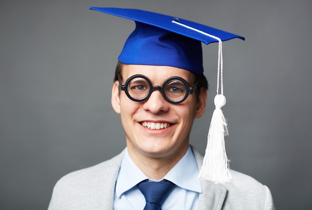 Close-up of clever boy with graduation cap Free Photo