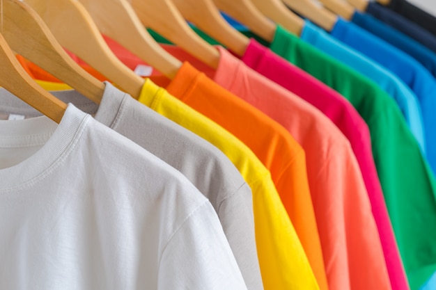 Premium Photo | Close up of colorful t-shirts on hangers