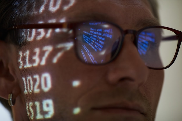 Premium Photo | Close-up of computer hacker in eyeglasses working with ...