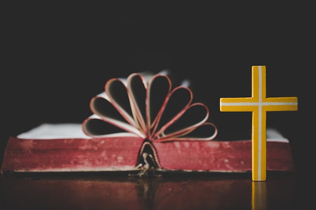 Premium Photo | Close up cross with heart shape from holy bible on ...