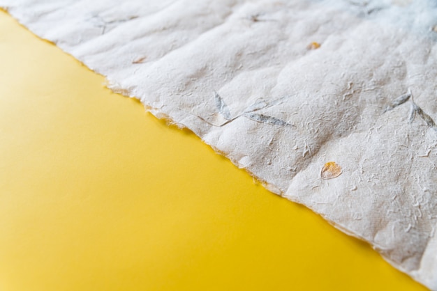 Premium Photo Close Up Crumpled Japanese Paper Washi On Yellow Paper In One Third Ratio Paper Texture Background With Copy Space