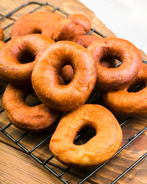 Close-up of delicious brown donuts on metallic tray over counter | Free ...