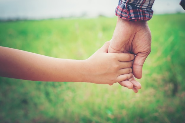 Close up of father holding his daughter hand, so sweet,family ti Free Photo